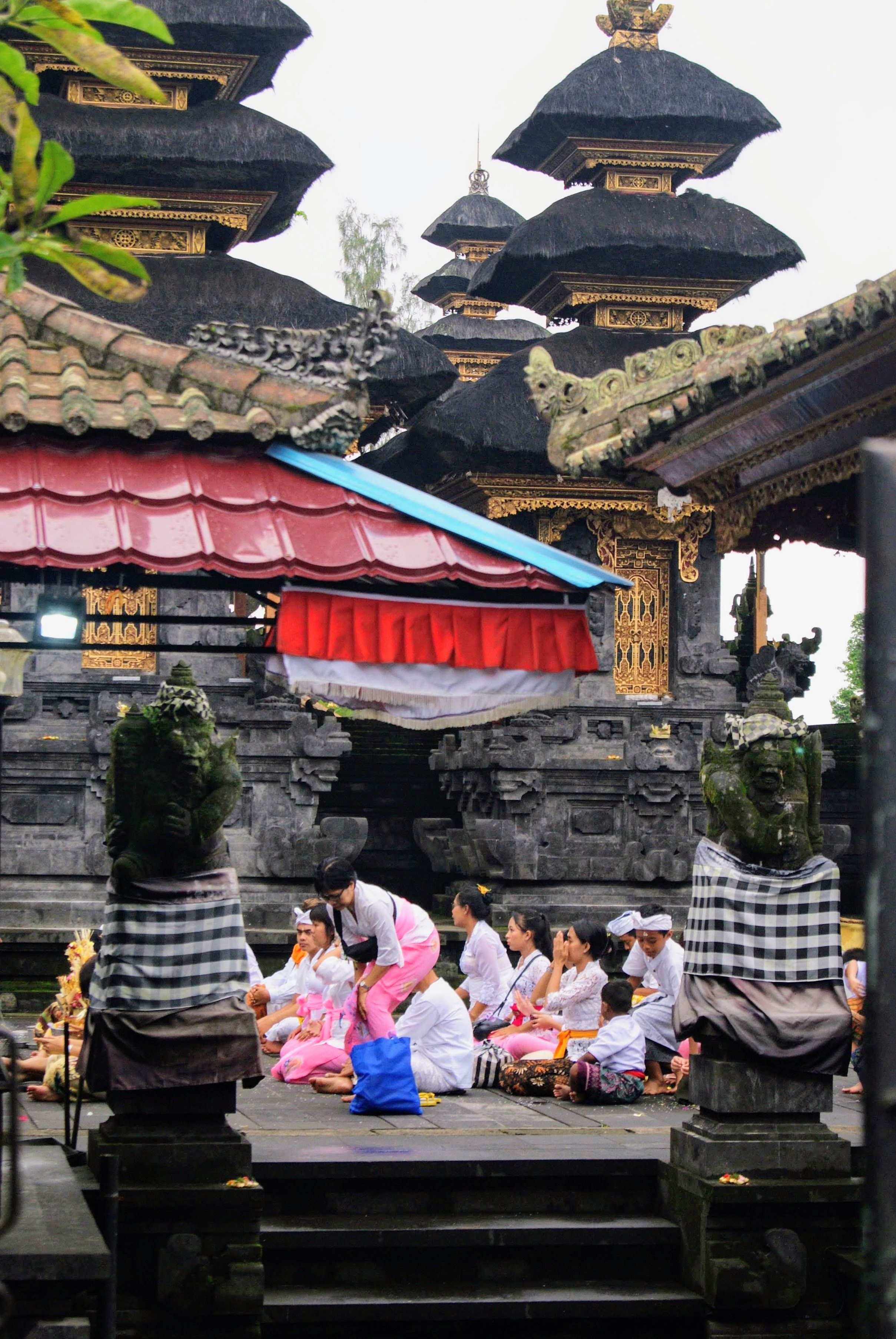 Balinese temple ceremony with traditional offerings and incense in Bali